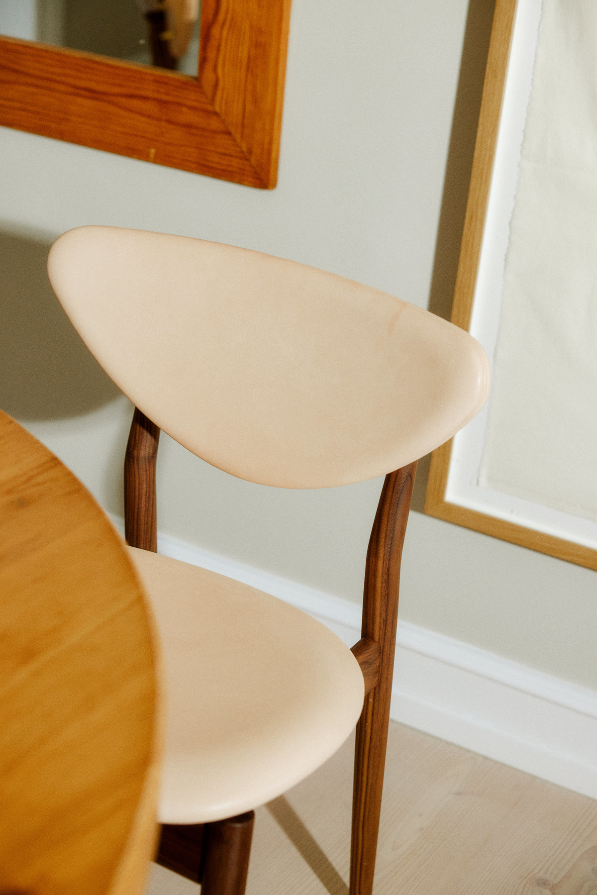 108 Dining Chair detail of the leather back and wooden frame; original walnut design reference