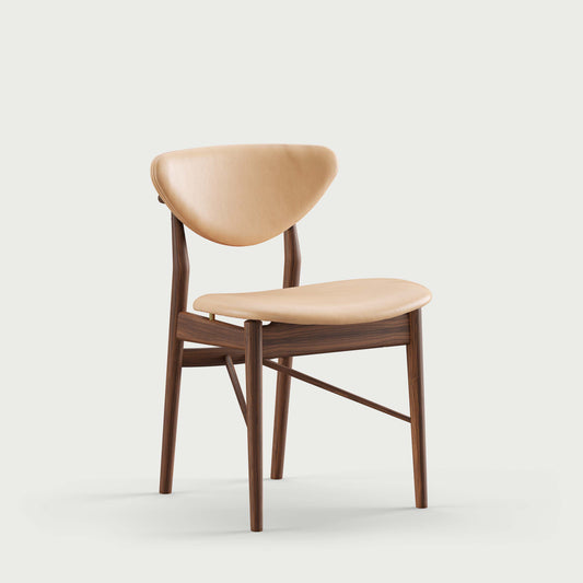108 Dining Chair three-quarter view with natural leather upholstery; original walnut design reference
