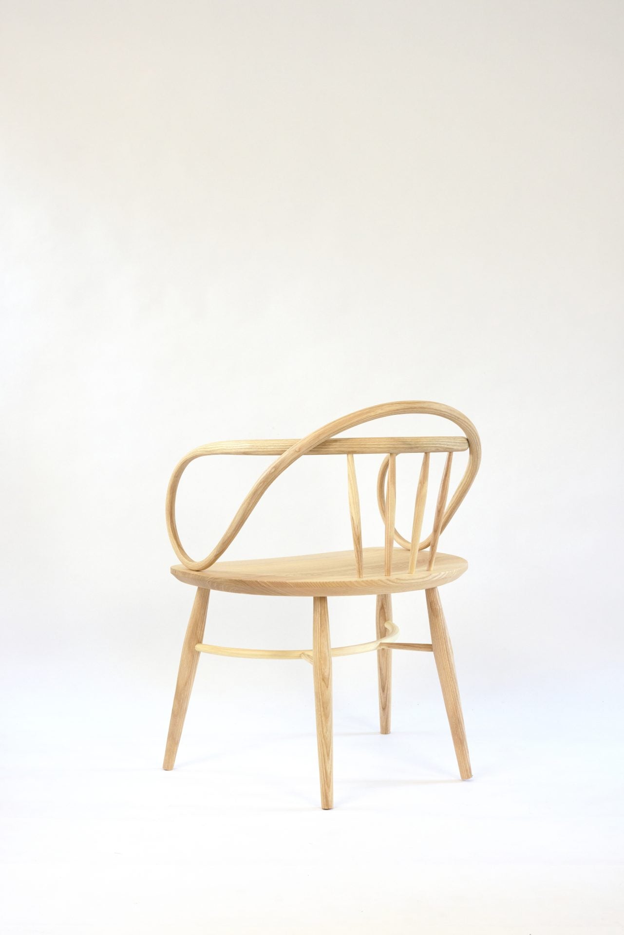 Solid ash and teak Windsor chair with a double bow back.