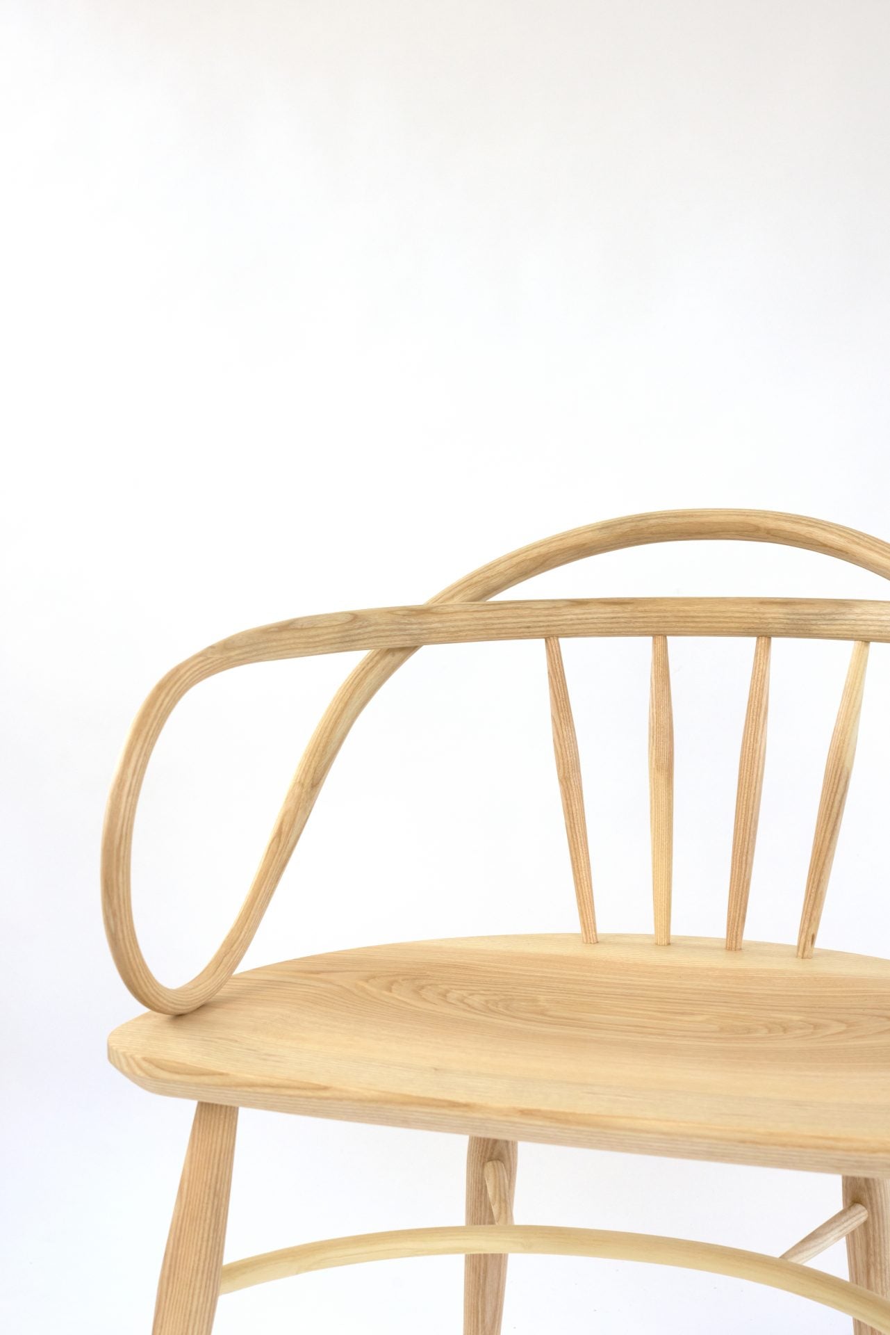 Solid ash and teak Windsor chair with a double bow back.