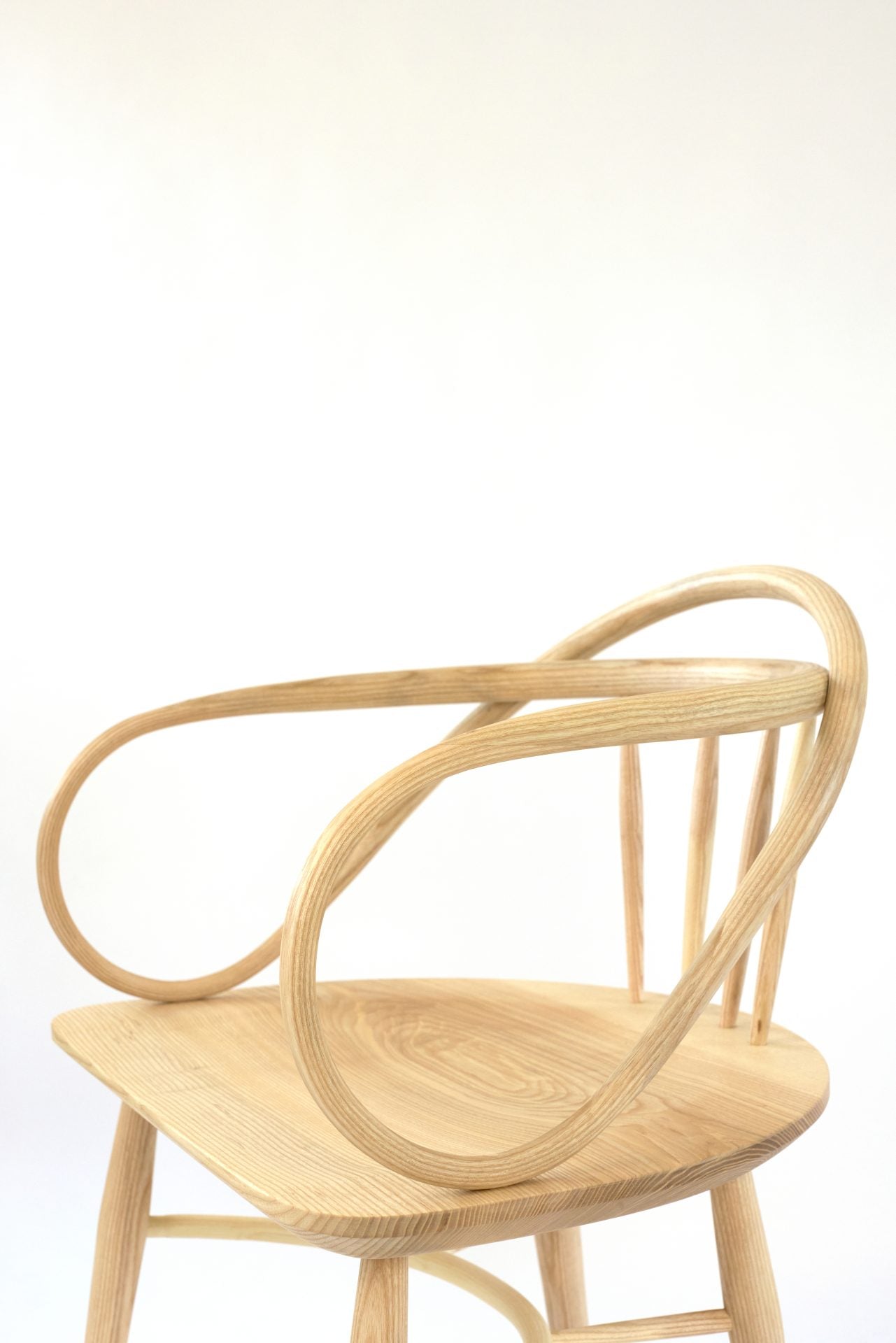 Solid ash and teak Windsor chair with a double bow back and contoured seat.