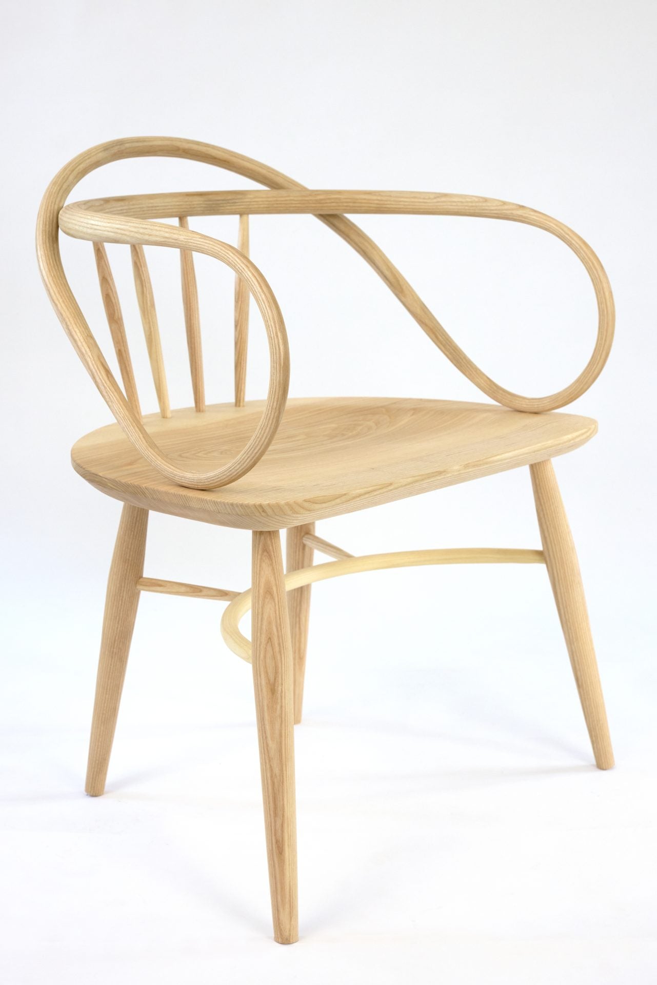 Solid ash and teak Windsor chair with a double bow back and contoured seat.