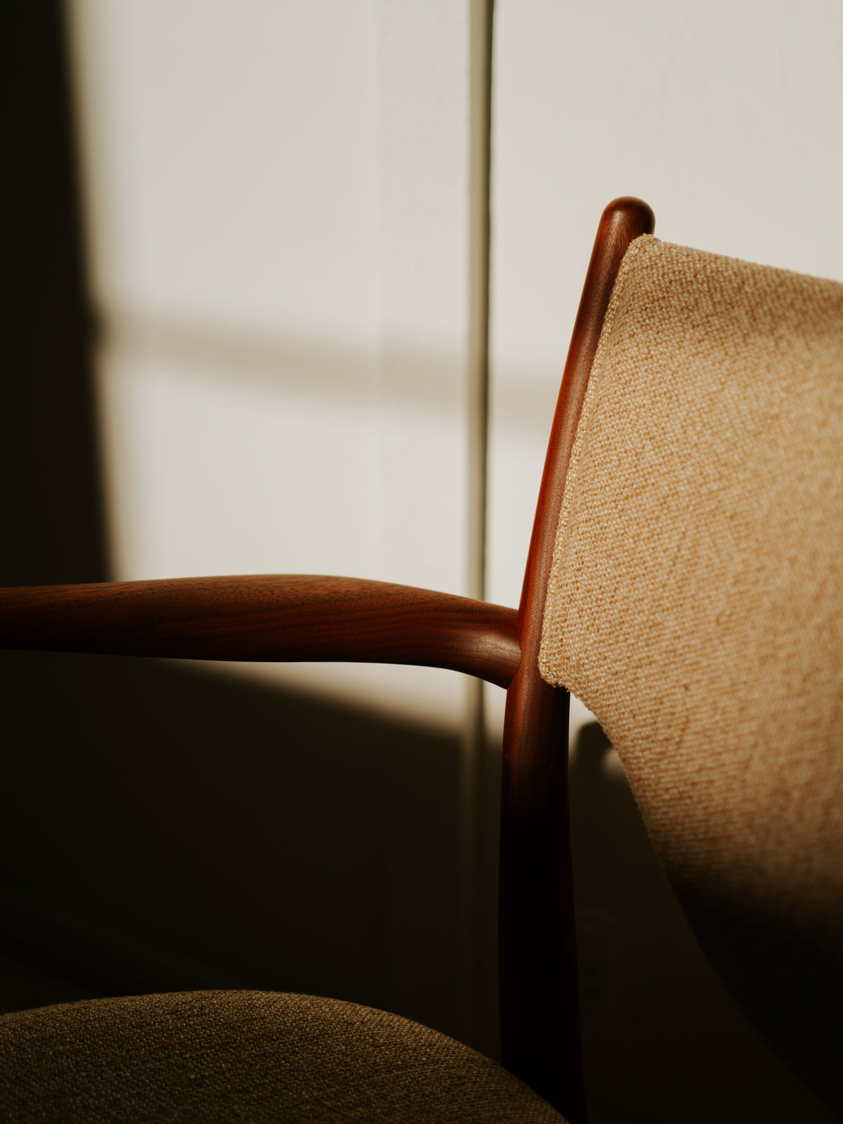 46 Dining Armchair detail of the curved arm and upholstered back; original walnut design reference