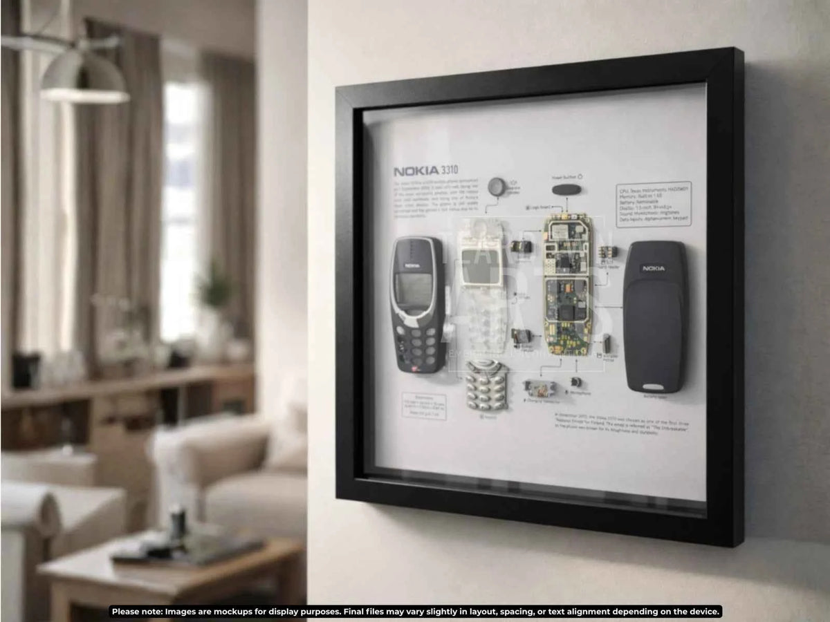 A framed, disassembled Nokia 3310 mobile phone displayed as wall art in a black frame.
