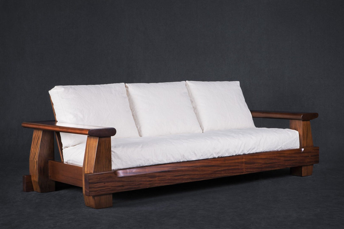 Mário de Andrade Sofa three-quarter view with white cushions; original reclaimed peroba rosa design reference
