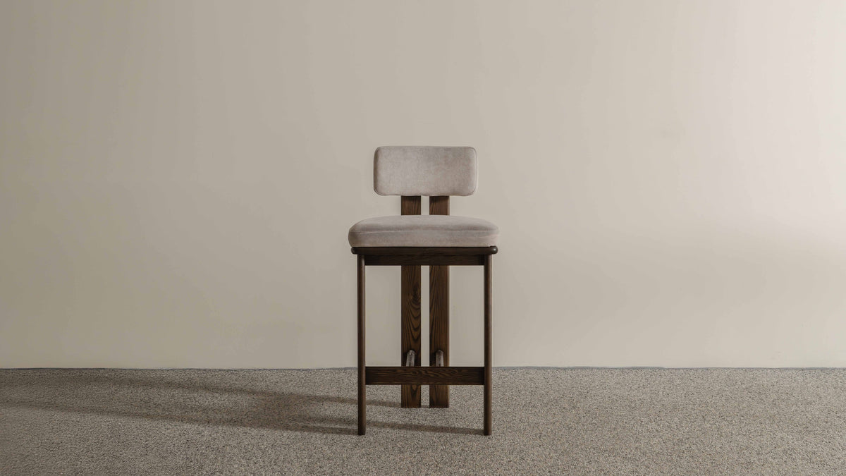 Eum Bar Chair original Eastern Edition reference — front view; original timber and upholstery, not a Gulmohar-made teak chair.