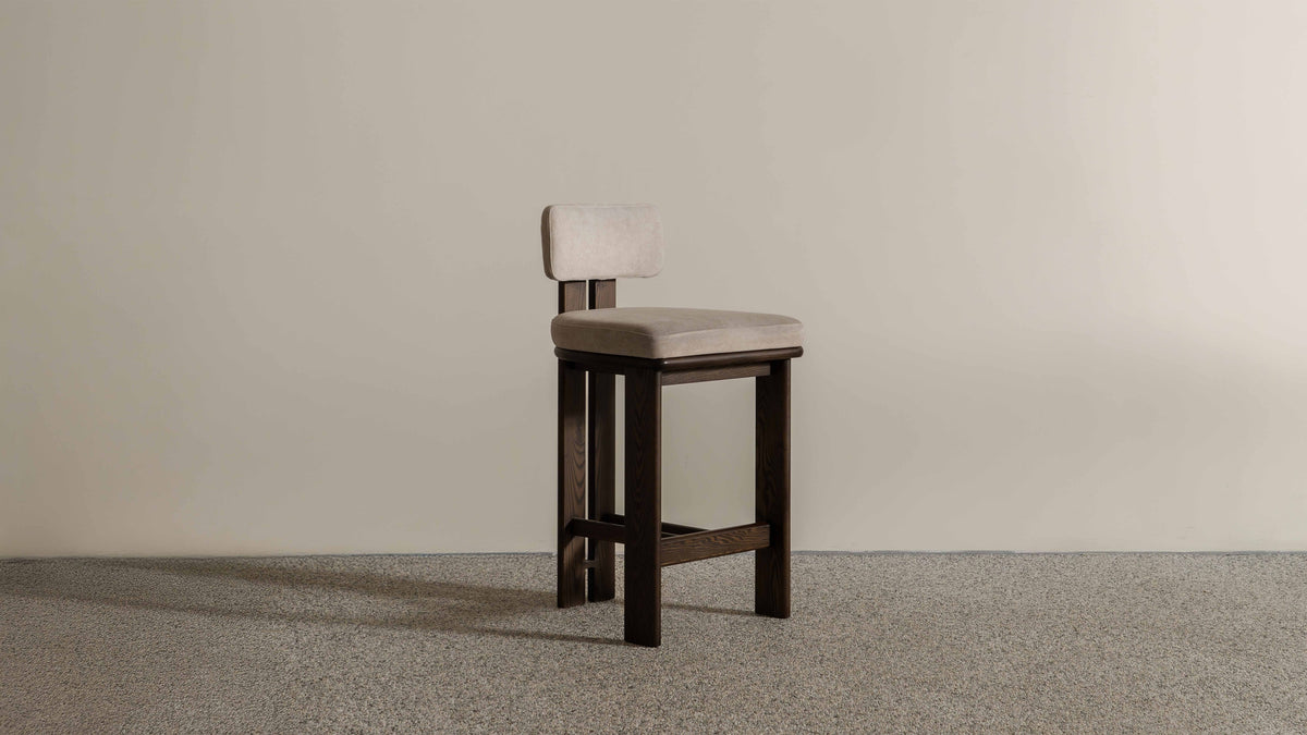 Eum Bar Chair original Eastern Edition reference — side view; original timber and upholstery, not a Gulmohar-made teak chair.