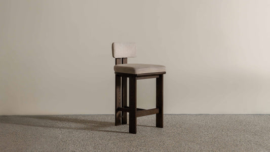 Eum Bar Chair original Eastern Edition reference — side view; original timber and upholstery, not a Gulmohar-made teak chair.