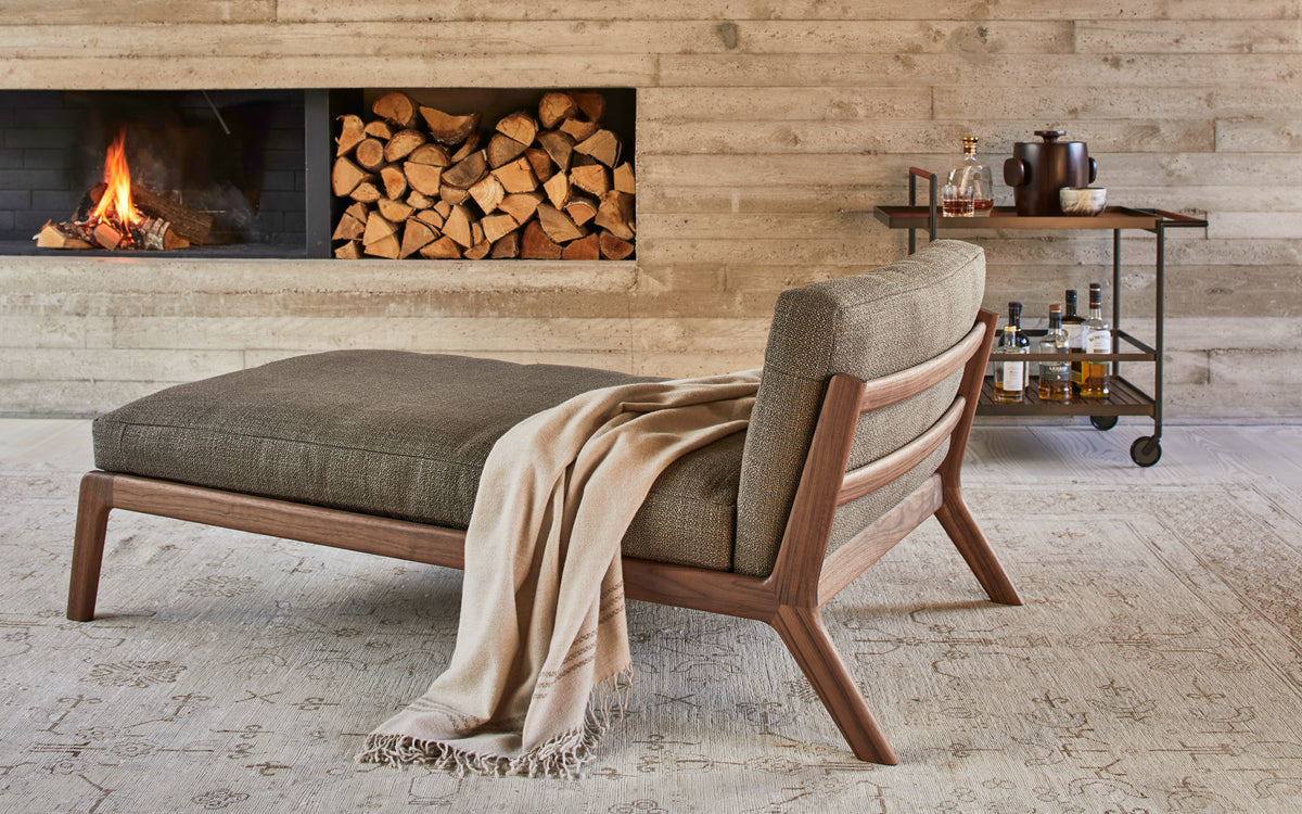 SOVA chaise longue with walnut frame and fabric cushions in a living room; original more design reference
