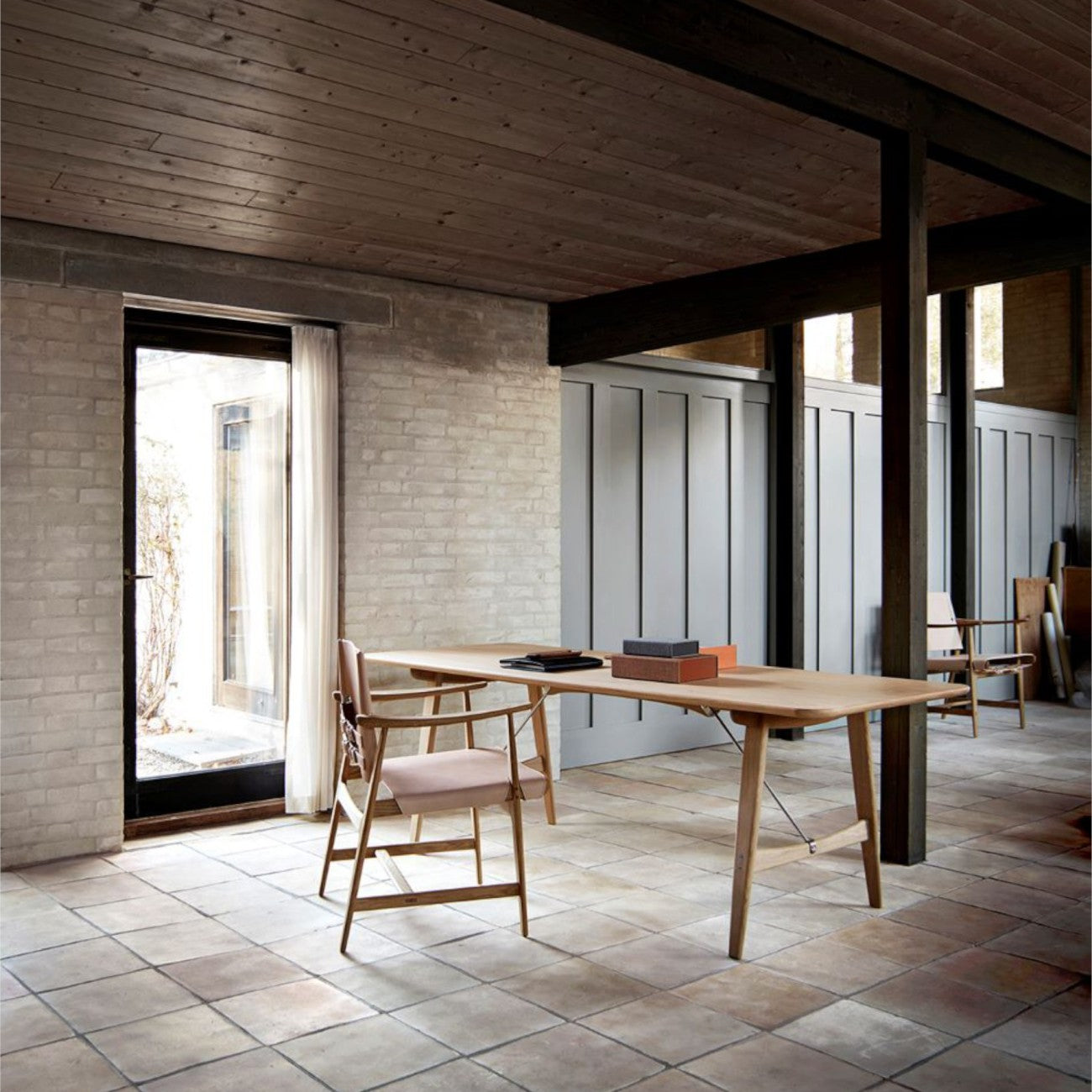 The BM1160 Hunting Table in solid wood with metal brace bars and matching wooden chairs.