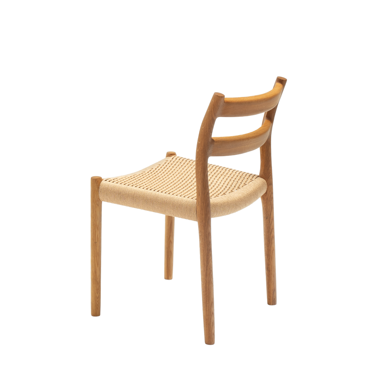 Original J.L. Møller Model 84 design reference — rear three-quarter view. Source: J.L. Møller. Custom Gulmohar teak version may differ.