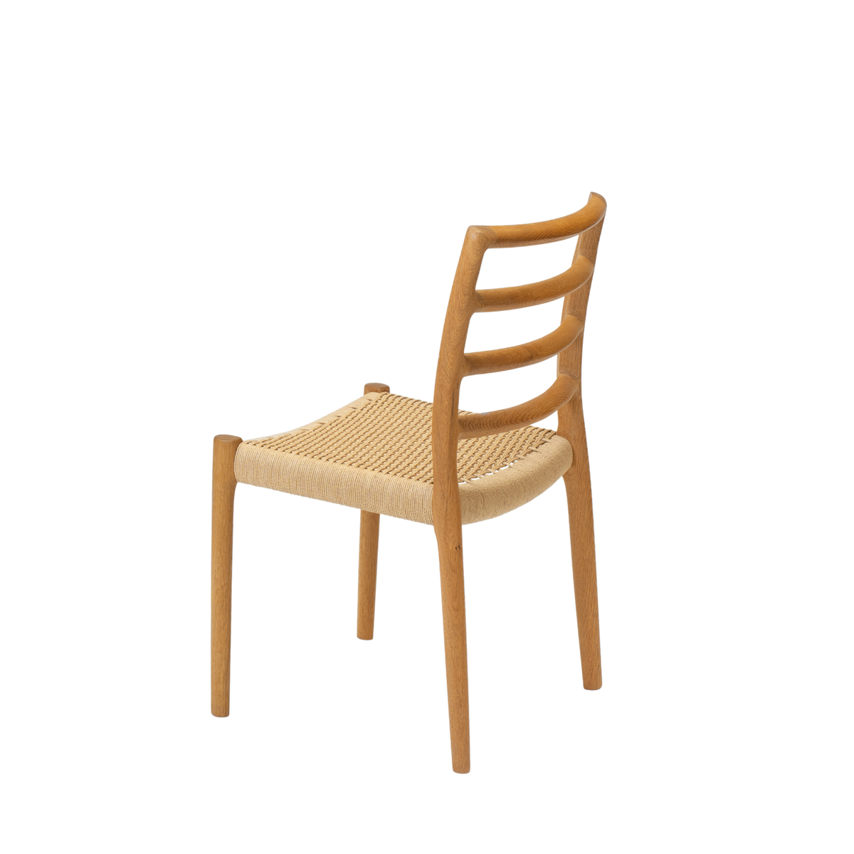Original J.L. Møller Model 85 design reference — rear three-quarter view. Source: J.L. Møller. Custom Gulmohar teak version may differ.