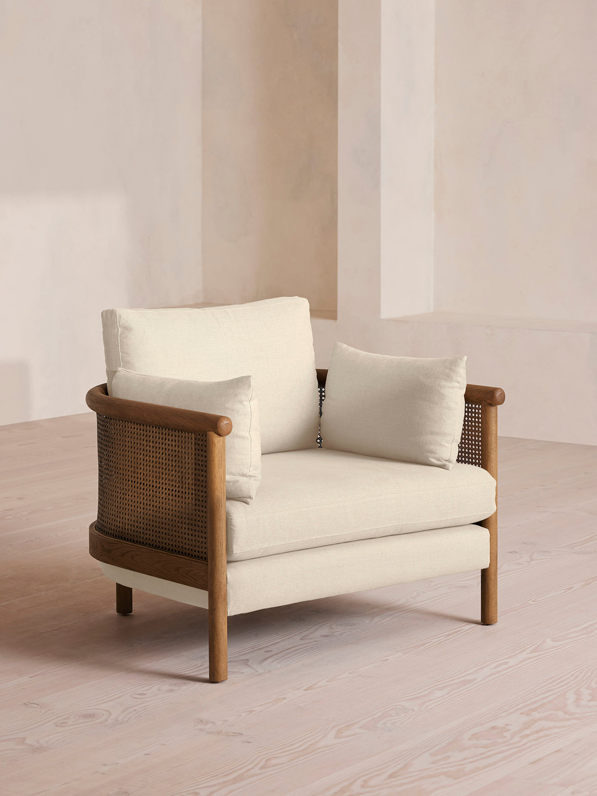 Soho Home Sydney Cane Armchair, front three-quarter view. Original design reference; Gulmohar custom version uses teak.