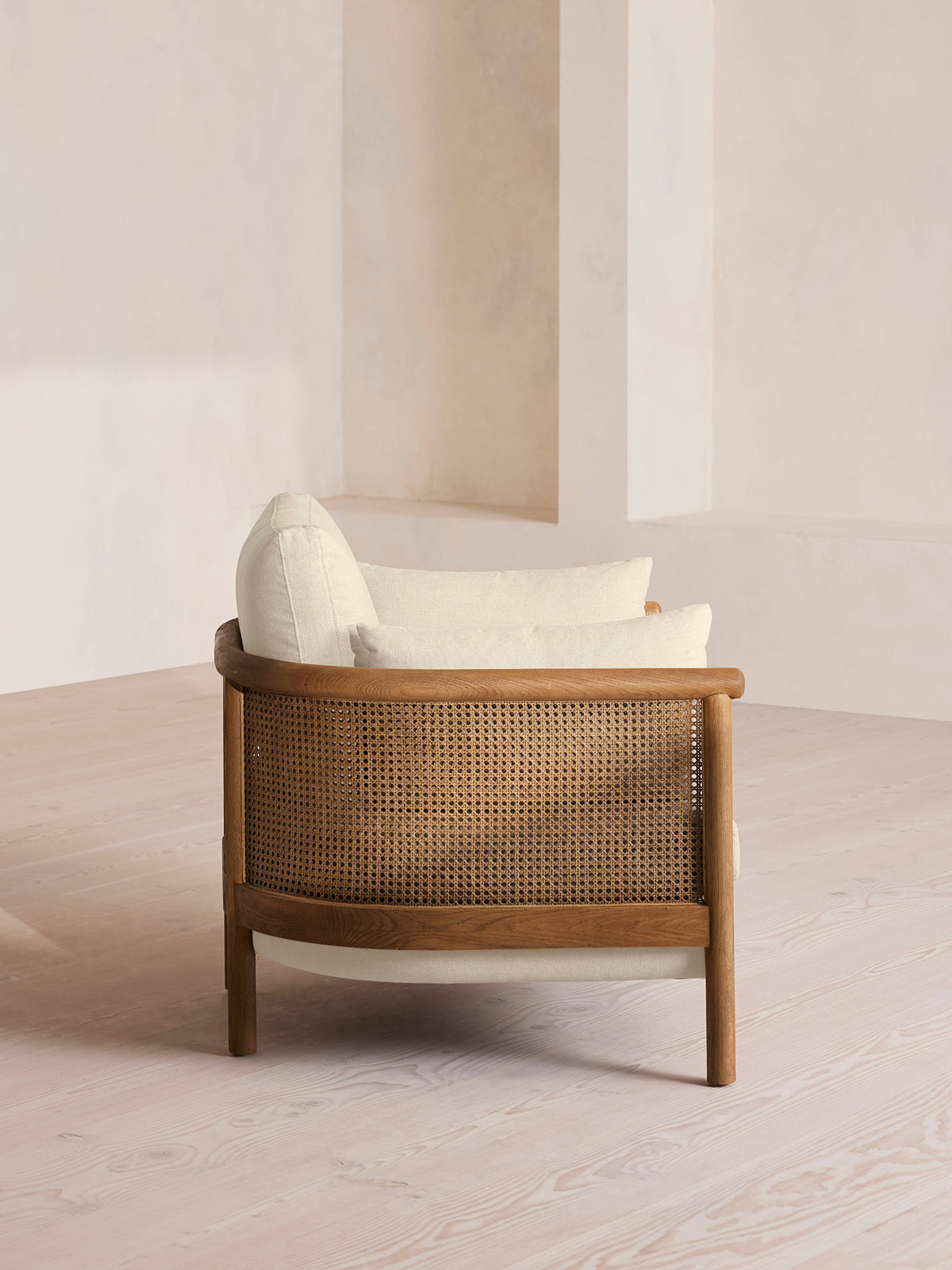 Soho Home Sydney Cane Armchair, side view. Original design reference; Gulmohar custom version uses teak.