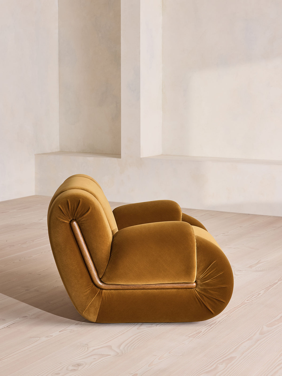 Soho Home Umbria Armchair, side view. Original design reference; Gulmohar custom version uses teak.